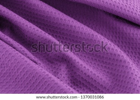Violet corrugated cotton textile - close up of fabric texture. Cotton Fabric Texture. Violet Clothing Background. Text Space. Abstract background and texture for designers.