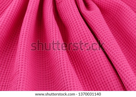 Pink corrugated cotton textile - close up of fabric texture. Cotton Fabric Texture. Pink Clothing Background. Text Space. Abstract background and texture for designers.