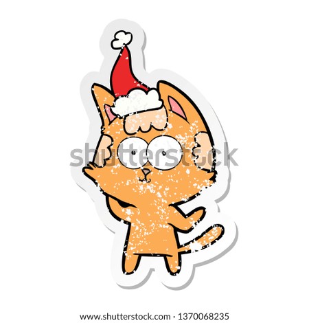 happy hand drawn distressed sticker cartoon of a cat wearing santa hat