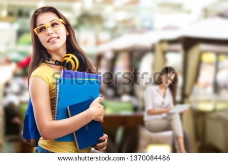 Headshot of young happy attractive asian student smiling and looking at camera with friends on outdoor university background. Asian woman in self future education or personalized learning concept