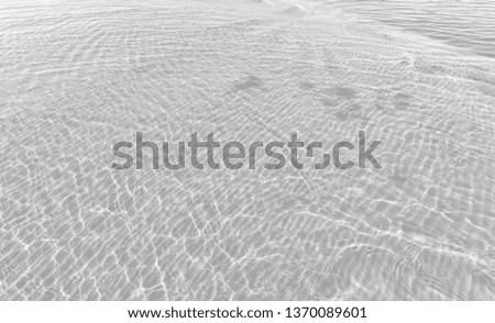 Rippled water texture background. Wave abstract background in dark red tonality in light gray tonality