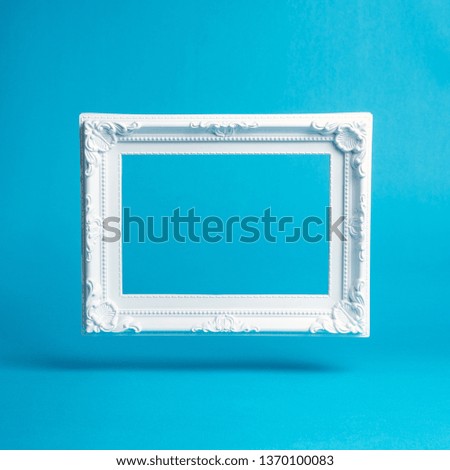 White vintage frame on blue background. Minimal composition.