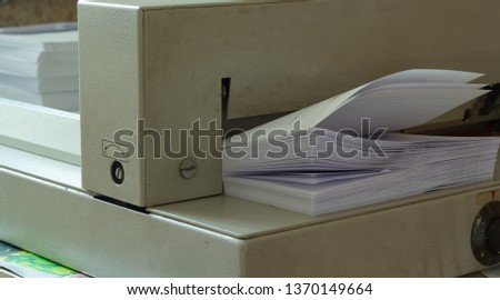 A pack of printed white paper cuts guillotine