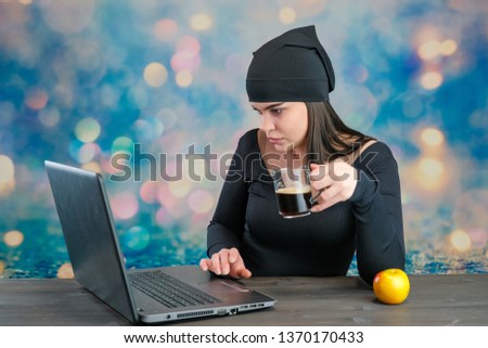 I'll tell you everything. Studio photo portrait of a cute young Caucasian brunette girl with an apple, coffee and laptop looking straight into the camera on a colored background. Studio concept.