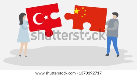 Couple holding two puzzles pieces with Turkish and Chinese flags. Turkey and China national symbols together.