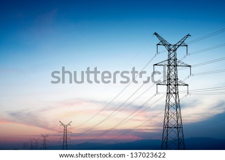 Pylon and transmission power line in sunset Royalty-Free Stock Photo #137023622
