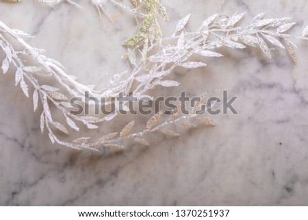 Shiny Christmas twigs on a marble background