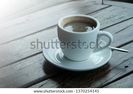 Well mixed hot black coffee in white coffee cup with space for write wording served in a restaurant in a coffee break time.