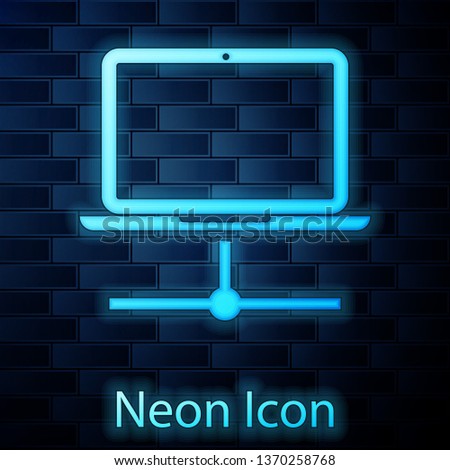 Glowing neon Computer network icon isolated on brick wall background. Laptop network. Internet connection. Vector Illustration