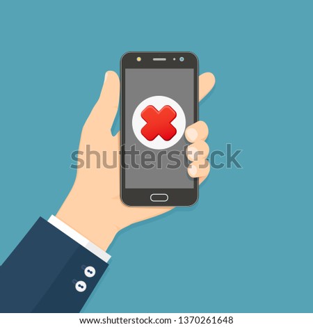Cross mark on smartphone screen. Hand holds smartphone. Mobile phone with red cross mark. Failure concept.