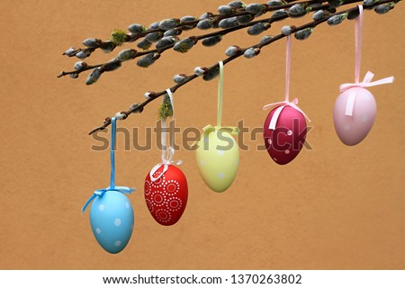 colourful Easter eggs hanging on a tree with ribbons stock photo