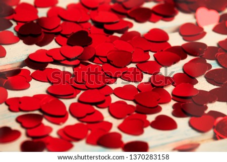 Red hearts confetti on wood background