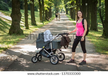 Active girl/mother with a pram in a park (Jeseník, Czech Republic)