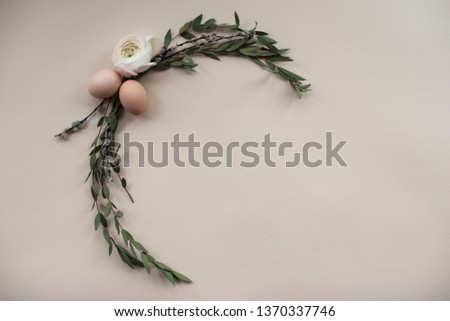 Happy Easter concept background
Easter egg decoration with eucalyptus, ranunculus and willow twigs. Easter card in pastel colors with light background and place for text. Green floral frame.