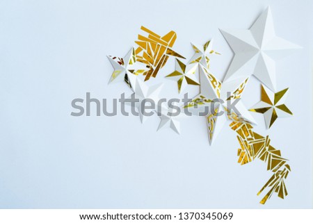 Stars cut from white paper on white background