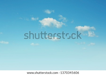 Blue sky background with clouds floating in soft blurry. Of free space for your texts and branding.