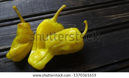 Pepperoncini peppers on rustic wooden background. Royalty-Free Stock Photo #1370361659