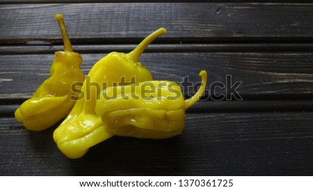Pepperoncini peppers on rustic wooden background. Royalty-Free Stock Photo #1370361725