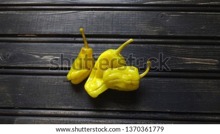 Pepperoncini peppers on rustic wooden background. Royalty-Free Stock Photo #1370361779