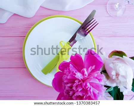 peony flower plate on pink wooden background