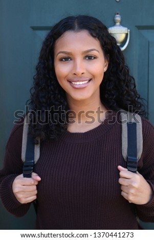 Columbus,Ohio/USA March 24, 2019:  Young College student on her way to school carrying a back pack. Royalty-Free Stock Photo #1370441273