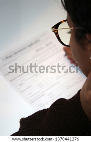 Student submitting her application for college admission. Royalty-Free Stock Photo #1370441276