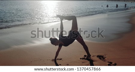 flexible girl engaged in gymnastics at sea
