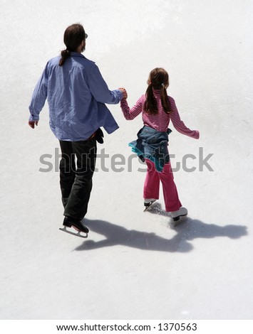 Father and daughter are skating together holding hands