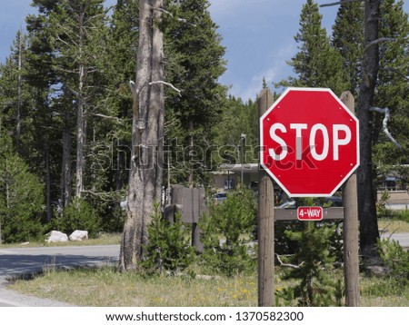Stop sign on a four-way intersection at Yellowstone National Park in Wyoming.
