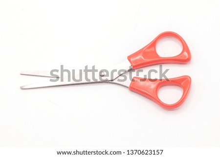 Red scissor on isolated white background.