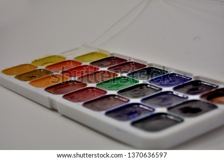 A box of watercolor paints on a white background