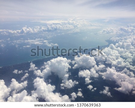 Clouds Cumulonimbus on the white sky, quaint take picture a high angle from the plane  at Thailand.
