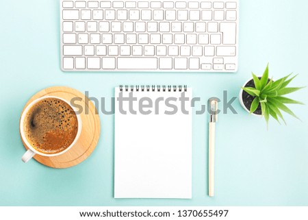 Creative work place background with keyboard, coffee and stationery and candle. Freelance, blogging or home office concept. Flat lay, top view. Copy space for your text.