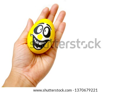 Perfect colorful handmade Easter eggs with smile eggs in human hand isolated on a white background. Easter day concepts. Funny decoration. Happy Easter.