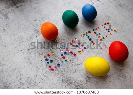 Easter wallpaper five colorful eggs and word Easter on wooden background