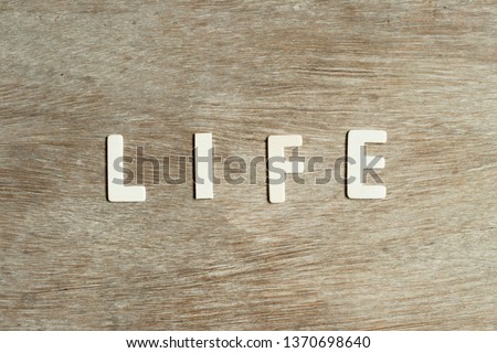 Alphabet letter in word life on wood background