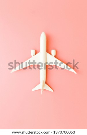 Model plane, airplane on pink pastel color background with copy space.Flat lay design.Travel concept on pink background. top view model plane on pink color background.