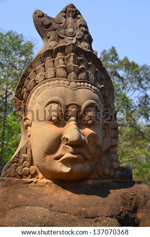 Stone Asuras hold the naga Vasuki on a bridge leading into the 12th century city of Angkor Thom.