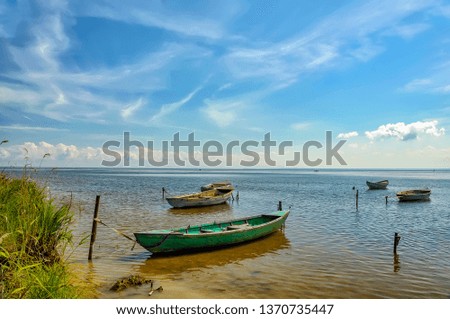 Fishing boats, standing on the pier in lake Ladoga. Sunny summer day. 