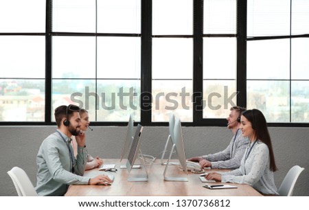 Technical support operators working in modern office