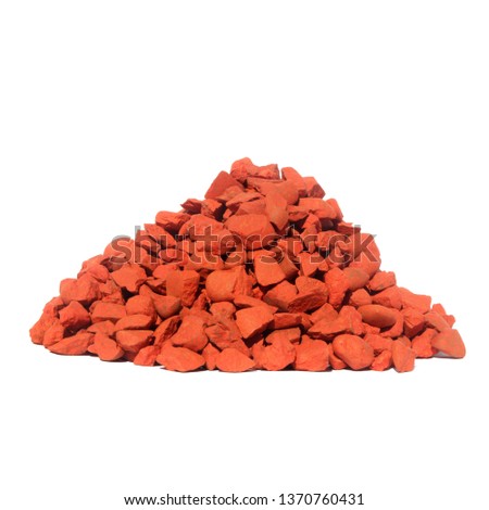A pile of colored orange stones isolated on white background. Stones for decoration.