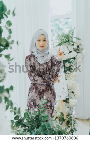 Cute female model wearing Baju Kebaya (Malaysia traditional dress for woman).Eid ul fitr fashion.