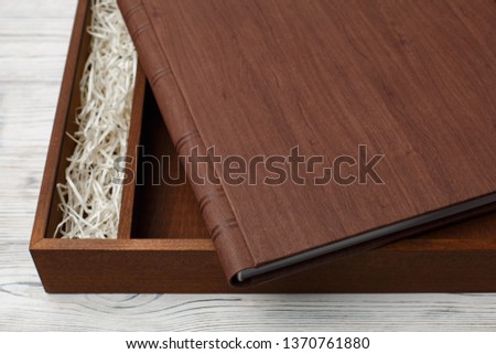 wedding photo book with wooden box.
cardboard box for a family photo album.
Box for wedding album on the wooden background.
Gift box with lid.