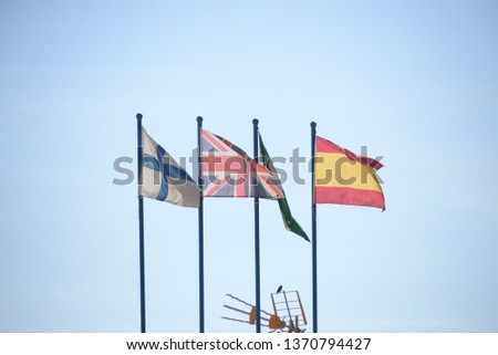 Four flags in the wind: Finland, Great Britain (Union Jack), autonomy Andalusia, Spain, in Fuengirola in the province of Malaga, Costa del Sol, Spain, on February 7, 2019