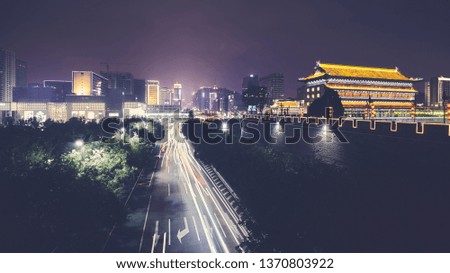 Xian skyline with City Wall at night, color toned picture, China.