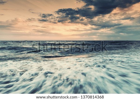 Sunrise on sea, landscape with sun and wave, seascape. Vintage stylization, retro film filter