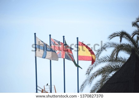 Four flags in the wind: Finland, Great Britain (Union Jack), autonomy Andalusia, Spain, in Fuengirola in the province of Malaga, Costa del Sol, Spain, on February 7, 2019