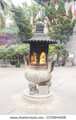 Close up of Fire incense burner at Nong Ping village