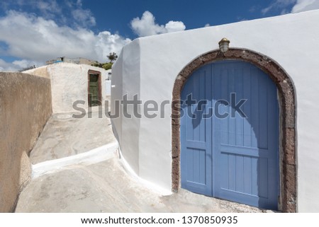 Traditional Greek architecture and blue door, Pyrgos village, Santorini Island, Greece. Beautiful details of Santorini island, white house and blue door
