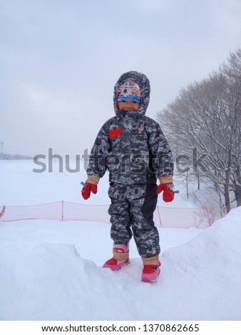 Asian little boy enjoying the snow